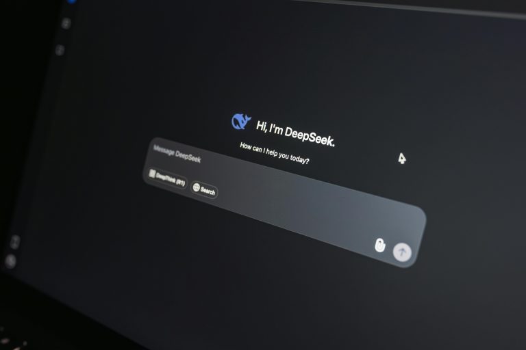 Close-up of DeepSeek AI chat interface on a laptop screen in low light.